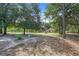 Shady backyard area with trees and lush green grass, and wooden pavilion in background at 10381 Hardwick Rd., Nichols, SC 29581