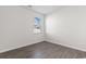 A bright bedroom with wood-look flooring and a window providing natural light and an outside view at 1128 Sennema Circle, Myrtle Beach, SC 29588