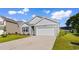 Charming single-story home featuring gray siding, an attached garage, and a well-maintained lawn at 1128 Sennema Circle, Myrtle Beach, SC 29588