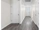 Bright hallway featuring gray wood floors, white doors and walls, plus recessed lighting at 1128 Sennema Circle, Myrtle Beach, SC 29588