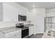 Modern kitchen featuring granite countertops, stainless steel appliances, and white cabinetry at 1128 Sennema Circle, Myrtle Beach, SC 29588