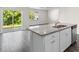 Modern kitchen island with granite countertops, sink, and stainless steel appliances at 1128 Sennema Circle, Myrtle Beach, SC 29588