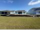 Expansive backyard showcases the home's exterior and ample green space, ideal for outdoor activities and enjoyment at 1205 Grinnell St., North Myrtle Beach, SC 29582