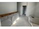Bathroom featuring a gray vanity with drawers, awaiting final installation, in a well-lit, unfinished space at 1205 Grinnell St., North Myrtle Beach, SC 29582
