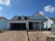 New construction home with light blue siding and an attached two car garage at 1205 Grinnell St., North Myrtle Beach, SC 29582