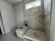 Elegant shower space with gray-tiled walls, a built-in bench, and modern fixtures ready for finishing touches at 1205 Grinnell St., North Myrtle Beach, SC 29582