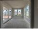 Bright sunroom features large windows and sliding doors overlooking backyard and lake, ready for customization and relaxation at 1205 Grinnell St., North Myrtle Beach, SC 29582