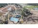 Aerial view of new construction community with pool, clubhouse, and green spaces surrounded by trees at 1239 Maxwell Dr., Little River, SC 29566