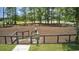 Community dog park surrounded by trees, a fence and featuring a dog park rules sign at 1239 Maxwell Dr., Little River, SC 29566