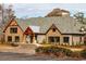 Beautiful clubhouse exterior showing stacked stone facade, gable accents and circular driveway at 1239 Maxwell Dr., Little River, SC 29566
