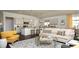 Open-concept living space with a kitchen island, neutral cabinetry, and comfortable seating arrangements at 1239 Maxwell Dr., Little River, SC 29566