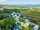 Aerial view showcasing the waterfront community with a marsh, waterway, and the home's lot outlined in white at 127 Brown Pelican Loop, Pawleys Island, SC 29585