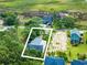 Aerial view highlighting a home's spacious lot near the marsh with a boat and lush surroundings at 127 Brown Pelican Loop, Pawleys Island, SC 29585