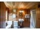 The bathroom is equipped with a simple vanity, toilet, and stall shower, accented by wood paneling at 127 Brown Pelican Loop, Pawleys Island, SC 29585