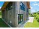 Exterior shot showing rustic wood siding with view of traditional windows at 127 Brown Pelican Loop, Pawleys Island, SC 29585