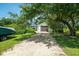 View of the detached garage surrounded by trees, offering privacy and seclusion at 127 Brown Pelican Loop, Pawleys Island, SC 29585