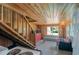 Galley kitchen with rustic wood walls, small dining table, and staircase to the upper floor at 127 Brown Pelican Loop, Pawleys Island, SC 29585