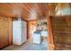 The galley kitchen features wood paneled walls, with a vintage stove and adjacent bathroom at 127 Brown Pelican Loop, Pawleys Island, SC 29585