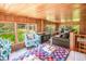 Cozy living room featuring wood paneling, plenty of natural light, and comfortable seating at 127 Brown Pelican Loop, Pawleys Island, SC 29585