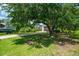 View of the yard with mature trees. There is a gravel driveway with a boat and garage visible through the trees at 127 Brown Pelican Loop, Pawleys Island, SC 29585