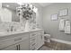 This bathroom features a double sink vanity with granite countertops and decorative wallpaper at 1428 Lanterns Rest Rd. # 1428, Myrtle Beach, SC 29579