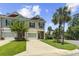 Well-kept townhouses showcasing manicured lawns, palm trees, and inviting driveways under a sunny sky at 1428 Lanterns Rest Rd. # 1428, Myrtle Beach, SC 29579