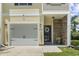 Charming townhome facade with garage, stone accents, decorative wreath and manicured lawn at 1428 Lanterns Rest Rd. # 1428, Myrtle Beach, SC 29579