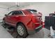 This home's garage features speckled floors, a red Cadillac XT5, and an automatic door opener at 1428 Lanterns Rest Rd. # 1428, Myrtle Beach, SC 29579