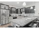Stylish kitchen with black and light gray cabinets, stainless steel appliances and a granite countertop island at 1428 Lanterns Rest Rd. # 1428, Myrtle Beach, SC 29579