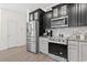 Modern kitchen featuring stainless steel appliances, granite countertops, and two-tone cabinetry at 1428 Lanterns Rest Rd. # 1428, Myrtle Beach, SC 29579