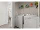 Bright laundry area features a modern washer and dryer and plenty of storage space on the shelving at 1428 Lanterns Rest Rd. # 1428, Myrtle Beach, SC 29579