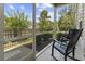 Relaxing screened porch with black rocking chairs offering views of the landscaped backyard at 1428 Lanterns Rest Rd. # 1428, Myrtle Beach, SC 29579