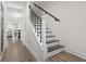 Elegant staircase with dark wood treads, white risers, and black iron railings, leading to the upper level at 1428 Lanterns Rest Rd. # 1428, Myrtle Beach, SC 29579