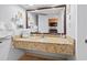 Bathroom with granite countertop, sink, towels, and mirror reflecting kitchenette at 1501 S Ocean Blvd. # 1039, Myrtle Beach, SC 29577
