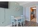 Dining area featuring light blue chairs and a white table with a view into the kitchen at 1501 S Ocean Blvd. # 1039, Myrtle Beach, SC 29577