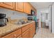 Kitchen with stainless steel appliances, granite counters, wood cabinets, and double sinks at 1501 S Ocean Blvd. # 1039, Myrtle Beach, SC 29577