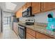 Kitchen featuring stainless appliances, granite countertops, and wood cabinets at 1501 S Ocean Blvd. # 1039, Myrtle Beach, SC 29577