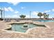 Outdoor hot tub and pool area with lounge chairs and palm trees on a sunny day at 1501 S Ocean Blvd. # 1039, Myrtle Beach, SC 29577