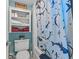 Bright bathroom boasts a decorative cabinet for storage and an attractive shower curtain at 1501 S Ocean Blvd. # 1548, Myrtle Beach, SC 29577