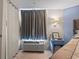 Cozy bedroom featuring a window AC unit, tiled flooring, and stylish furniture at 1501 S Ocean Blvd. # 1548, Myrtle Beach, SC 29577