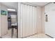 Hallway featuring tan tile floor with table and accordion door to the bedrooms at 1501 S Ocean Blvd. # 1548, Myrtle Beach, SC 29577