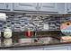 Kitchen sink features mosaic backsplash, stainless faucet and granite countertops at 1501 S Ocean Blvd. # 1548, Myrtle Beach, SC 29577