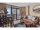 Cozy living room features a sliding glass door to the balcony with views of the city and the ocean at 1501 S Ocean Blvd. # 1548, Myrtle Beach, SC 29577