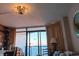 Bright living area featuring a decorative chandelier and sliding glass doors with ocean views at 1501 S Ocean Blvd. # 1548, Myrtle Beach, SC 29577