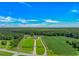 Large property featuring a long driveway, a lush lawn, and agricultural fields at 15810 County Line Rd., Andrews, SC 29510