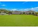 Expansive backyard featuring lush green lawn, and a glimpse of the well-kept home at 15810 County Line Rd., Andrews, SC 29510