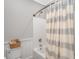 Bathroom featuring a shower/tub combo, white wainscoting and neutral decor at 15810 County Line Rd., Andrews, SC 29510