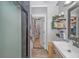 Bathroom featuring a walk-in shower, double sinks, open shelving, and linen storage at 15810 County Line Rd., Andrews, SC 29510