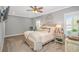 This bedroom features a tray ceiling, neutral decor, and ample natural light at 15810 County Line Rd., Andrews, SC 29510