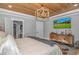 Inviting bedroom with tray ceiling, TV, and view to the en suite bathroom at 15810 County Line Rd., Andrews, SC 29510